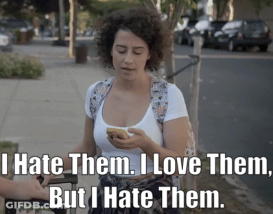 A Woman Holding A Cell Phone With The Words " I Hate Them I Love Them But I Hate Them " On The Bottom GIF