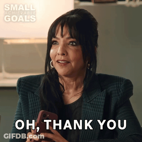 A Woman Holding A Cell Phone With The Words Oh Thank You Behind Her GIF