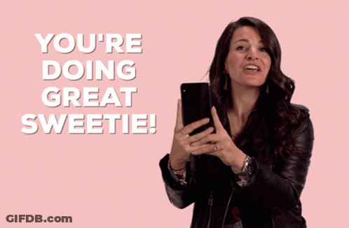 A Woman Holding A Cell Phone With The Words You 'Re Doing Great Sweetie GIF
