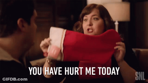 A Woman Holding A Christmas Stocking With The Words You Have Hurt Me Today GIF