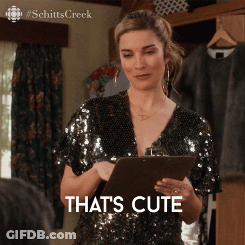A Woman Holding A Clipboard With The Words That 'S Cute Written On It GIF