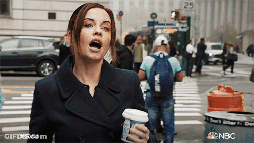 A Woman Holding A Cup Of Coffee In Front Of A Sign That Says 25 On It GIF
