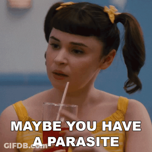 A Woman Holding A Drink With A Straw And Maybe You Have A Parasite Written On The Bottom GIF
