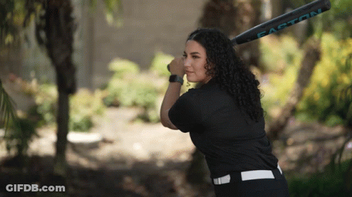 A Woman Holding A Easton Baseball Bat In Her Hand GIF
