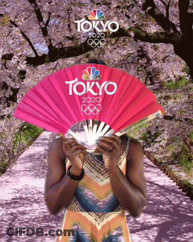 A Woman Holding A Fan That Says Tokyo 2020 GIF