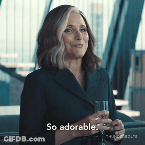 A Woman Holding A Glass Of Wine And Saying So Adorable GIF