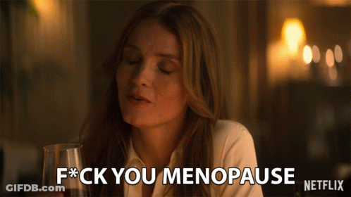 A Woman Holding A Glass Of Wine Says F * Ck You Menopause GIF