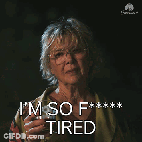 A Woman Holding A Glass Of Wine With The Words I 'M So F *** Tired GIF