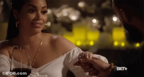 A Woman Holding A Man 'S Hand With A Bet Logo On The Bottom GIF