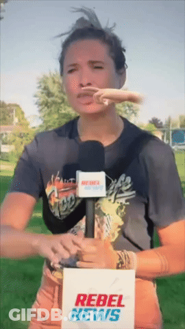 A Woman Holding A Microphone And A Rebel News Sign GIF