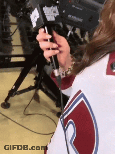 A Woman Holding A Microphone That Says Showtime GIF