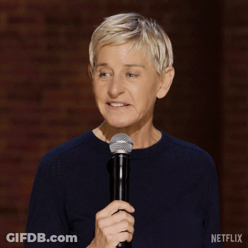 A Woman Holding A Microphone With A Netflix Logo On The Bottom Right GIF