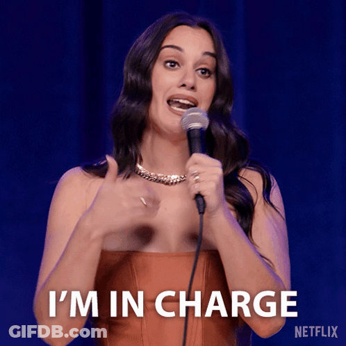 A Woman Holding A Microphone With The Words I 'M In Charge On The Bottom GIF