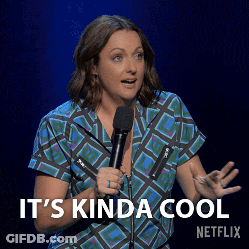 A Woman Holding A Microphone With The Words " It 'S Kinda Cool " Below Her GIF