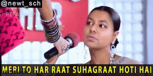 A Woman Holding A Microphone With The Words Meri To Har Raat Suhagraat Hoti Hai GIF
