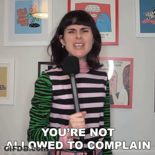 A Woman Holding A Microphone With The Words You 'Re Not Allowed To Complain Below Her GIF