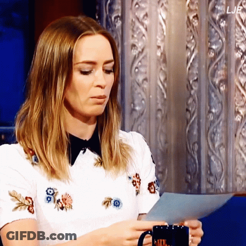 A Woman Holding A Mug And A Piece Of Paper With The Letters Ljb On The Bottom GIF