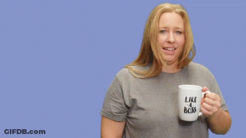 A Woman Holding A Mug That Says Like A Boss On It GIF