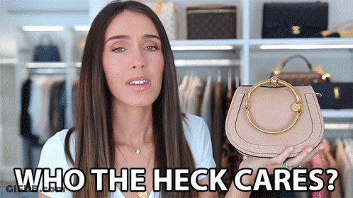 A Woman Holding A Purse With The Words Who The Heck Cares GIF