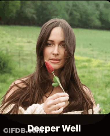 A Woman Holding A Red Flower With The Words Deeper Well Written Below Her GIF