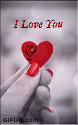 A Woman Holding A Red Heart With The Words I Love You On The Bottom GIF