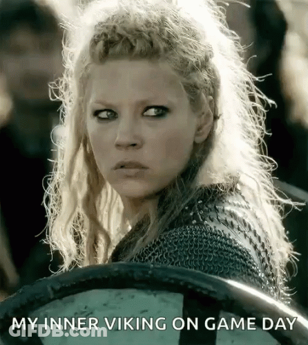 A Woman Holding A Shield With The Words " My Inner Viking On Game Day " Written Below Her GIF