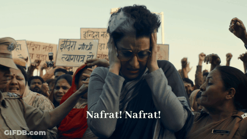 A Woman Holding A Sign That Says Nafrat Is Surrounded By Protesters GIF
