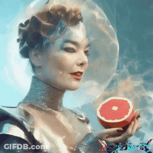 A Woman Holding A Slice Of Grapefruit With Smoke Coming Out Of Her Head GIF