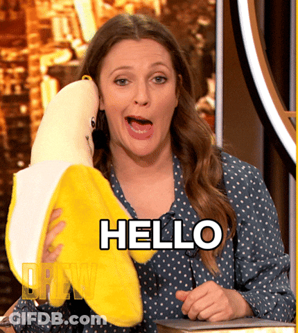 A Woman Holding A Stuffed Banana With The Word Hello Written On It GIF