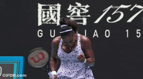 A Woman Holding A Tennis Racket In Front Of A Sign That Says Guiao 15 GIF