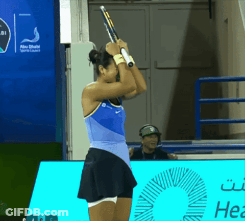 A Woman Holding A Tennis Racket In Front Of An Abu Dhabi Sports Lounge Sign GIF