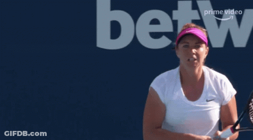 A Woman Holding A Tennis Racquet In Front Of A Betting Logo GIF