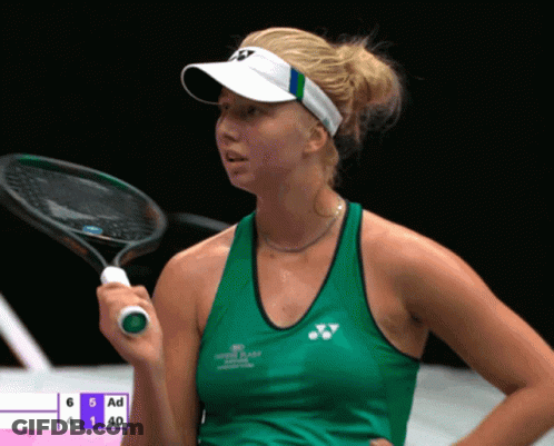 A Woman Holding A Tennis Racquet In Front Of A Scoreboard That Says Ad GIF