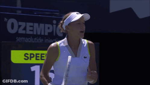 A Woman Holding A Tennis Racquet In Front Of A Scoreboard That Says Spee GIF