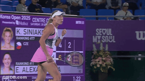 A Woman Holding A Tennis Racquet In Front Of A Seoul My Soul Sign GIF