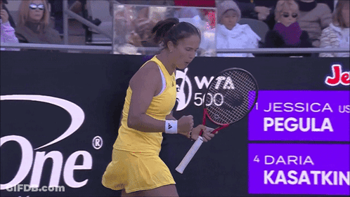 A Woman Holding A Tennis Racquet In Front Of A Sign That Says Jessica Pegula GIF