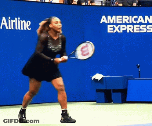 A Woman Holding A Tennis Racquet In Front Of A Wall That Says Airline GIF