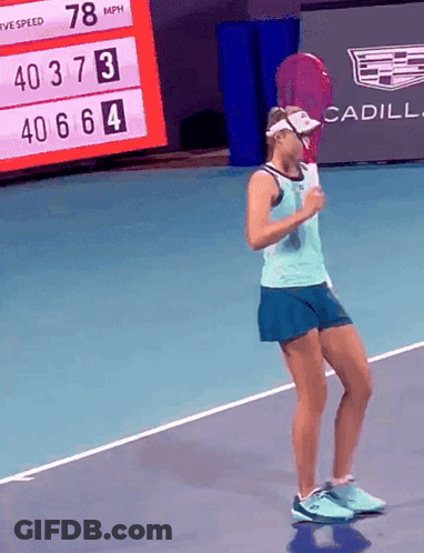 A Woman Holding A Tennis Racquet On A Tennis Court With A Cadillac Ad In The Background GIF