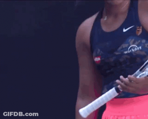 A Woman Holding A Tennis Racquet That Says Workday GIF