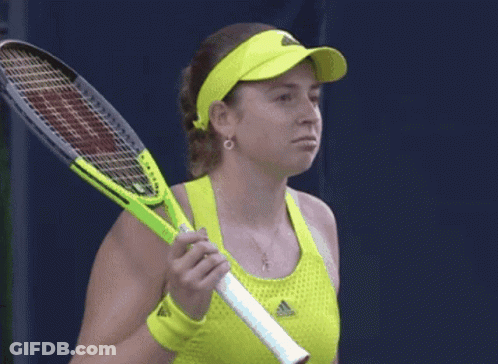 A Woman Holding A Tennis Racquet Wearing A Yellow Adidas Top GIF