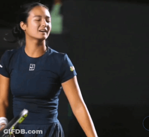 A Woman Holding A Tennis Racquet With A Shirt That Says ' Nike ' On It GIF
