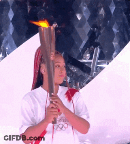 A Woman Holding A Torch That Says Tokyo 20 On It GIF