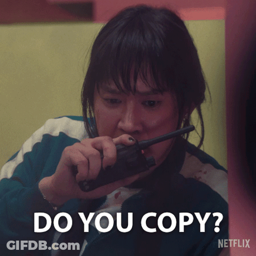 A Woman Holding A Walkie Talkie With The Words Do You Copy Written Below Her GIF