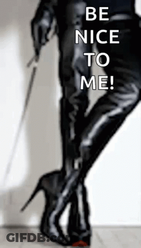 A Woman Holding A Whip With The Words Be Nice To Me Written On The Bottom GIF