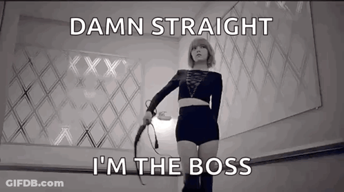 A Woman Holding A Whip With The Words " Damn Straight I 'M The Boss " Below Her GIF