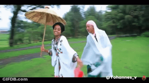 A Woman Holding An Umbrella Is Walking With A Man In A Raincoat GIF