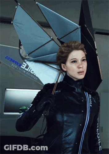 A Woman Holding An Umbrella With The Word Fragile On Her Jacket GIF