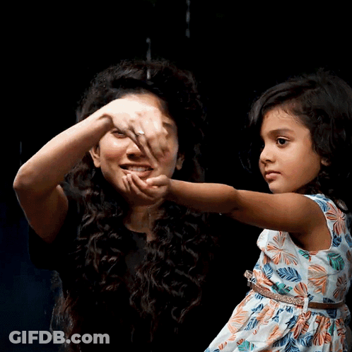 A Woman Holds A Little Girl 'S Hand And They Are Smiling GIF