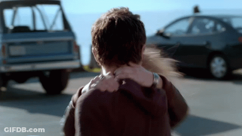 Woman Holds Man's Neck In Front Of Car GIF