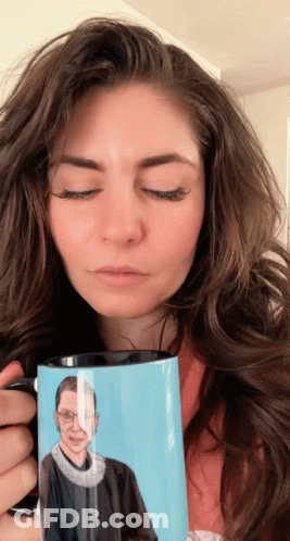 A Woman Holds A Mug With A Picture Of Ruth Bader Ginsburg GIF